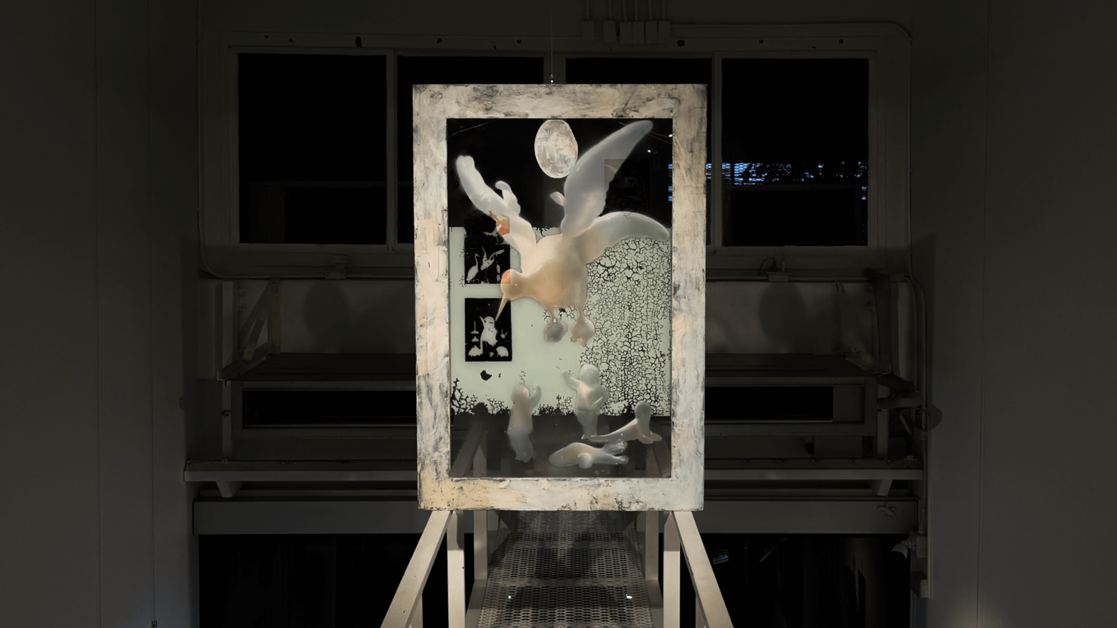 Mixed media artwork displayed in a framed structure, featuring ethereal elements and intricate textures.