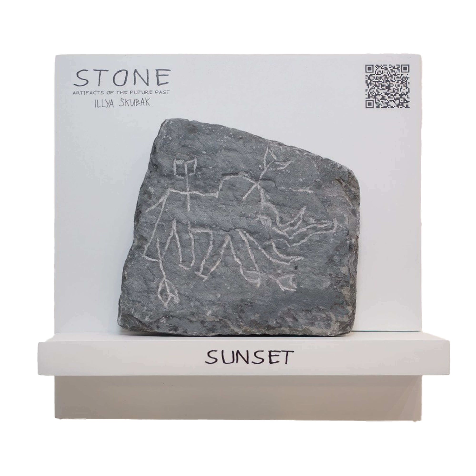 Stone artifact titled 'Sunset', featuring ancient carvings by Illya Skubak, mounted on display.