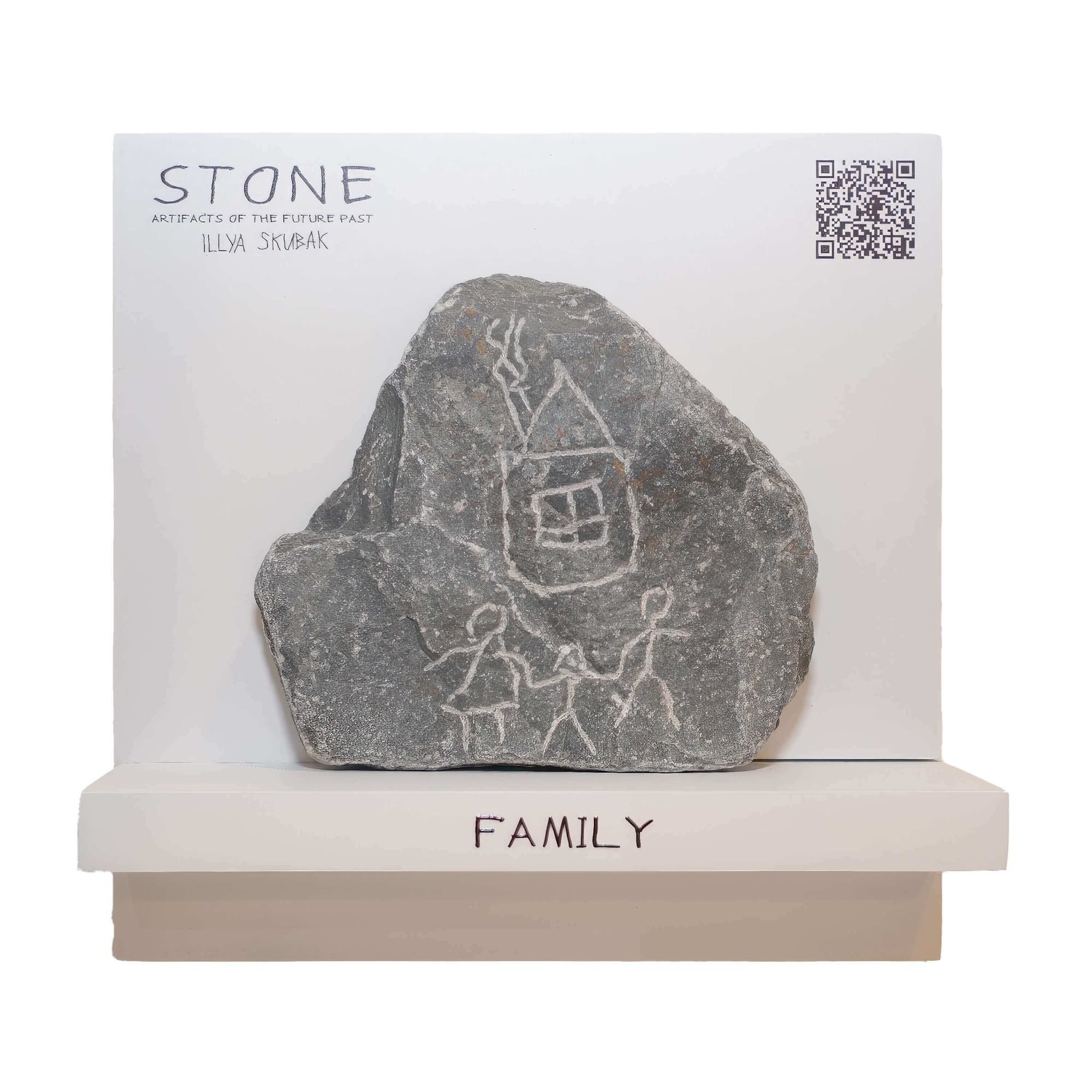Artistic stone with family drawings, titled 'FAMILY', presented on a shelf with minimalist display.
