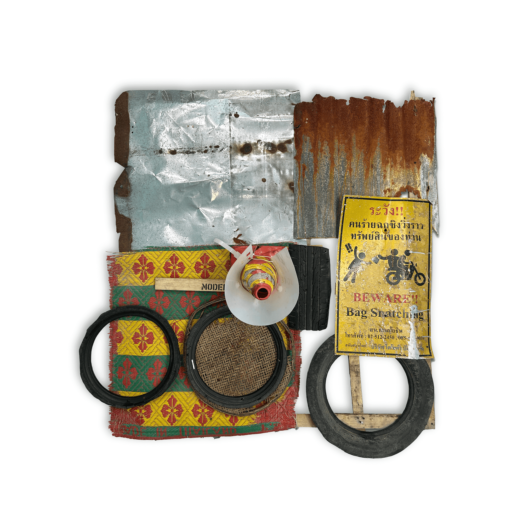 Mixed media artwork featuring recycled materials, including tin, tires, and colorful fabric, promoting environmental art.