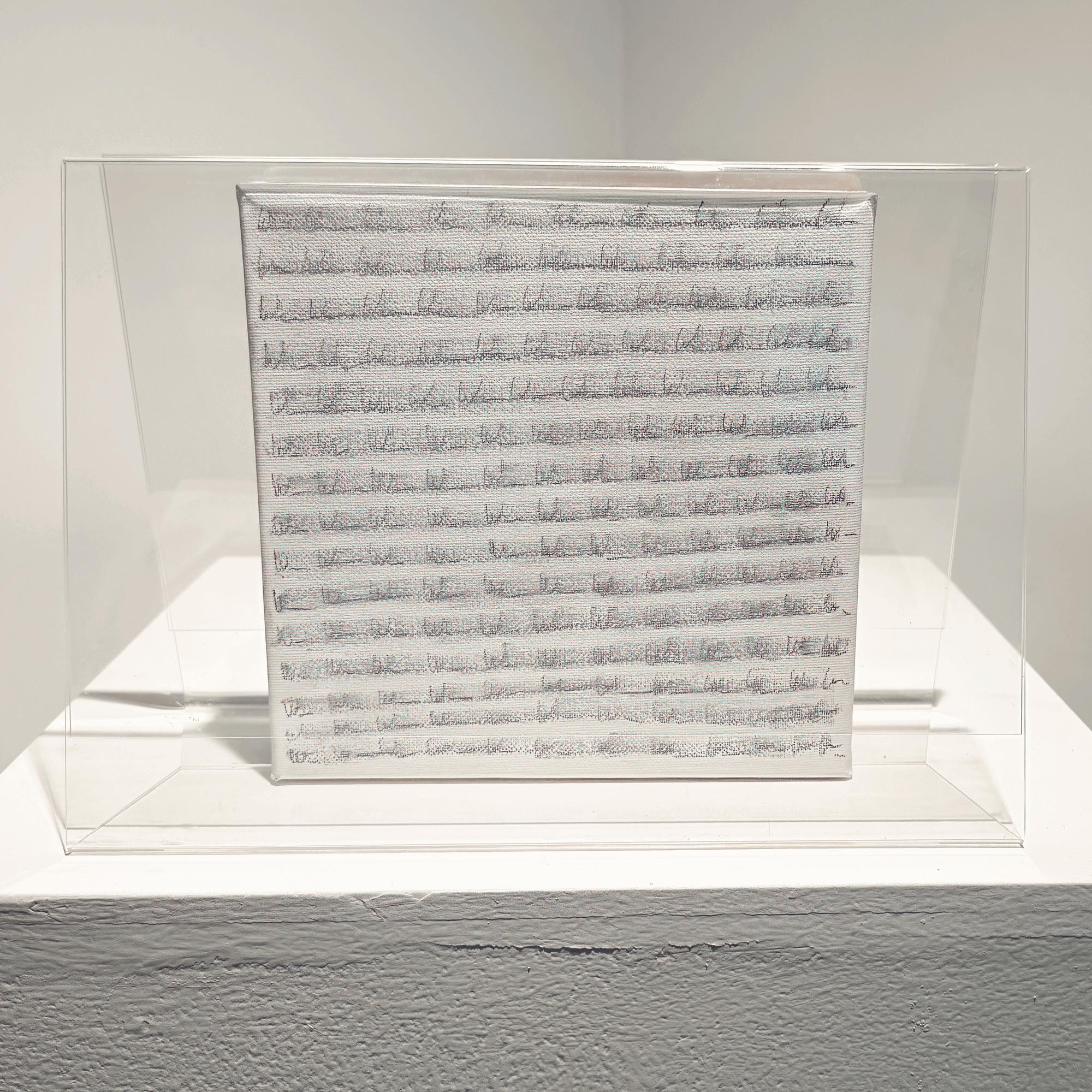 Mixed media artwork 'Imperfection' by Bryce in transparent casing, featuring layered surfaces and concealed details.