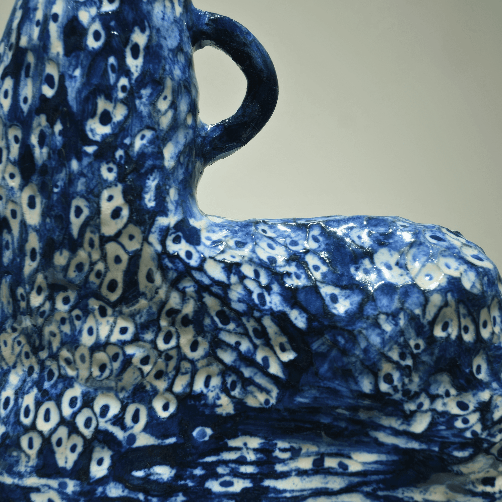 Hand-sculpted abstract ceramic piece by Supmanee Chaisansuk with intricate cobalt oxide glaze patterns.