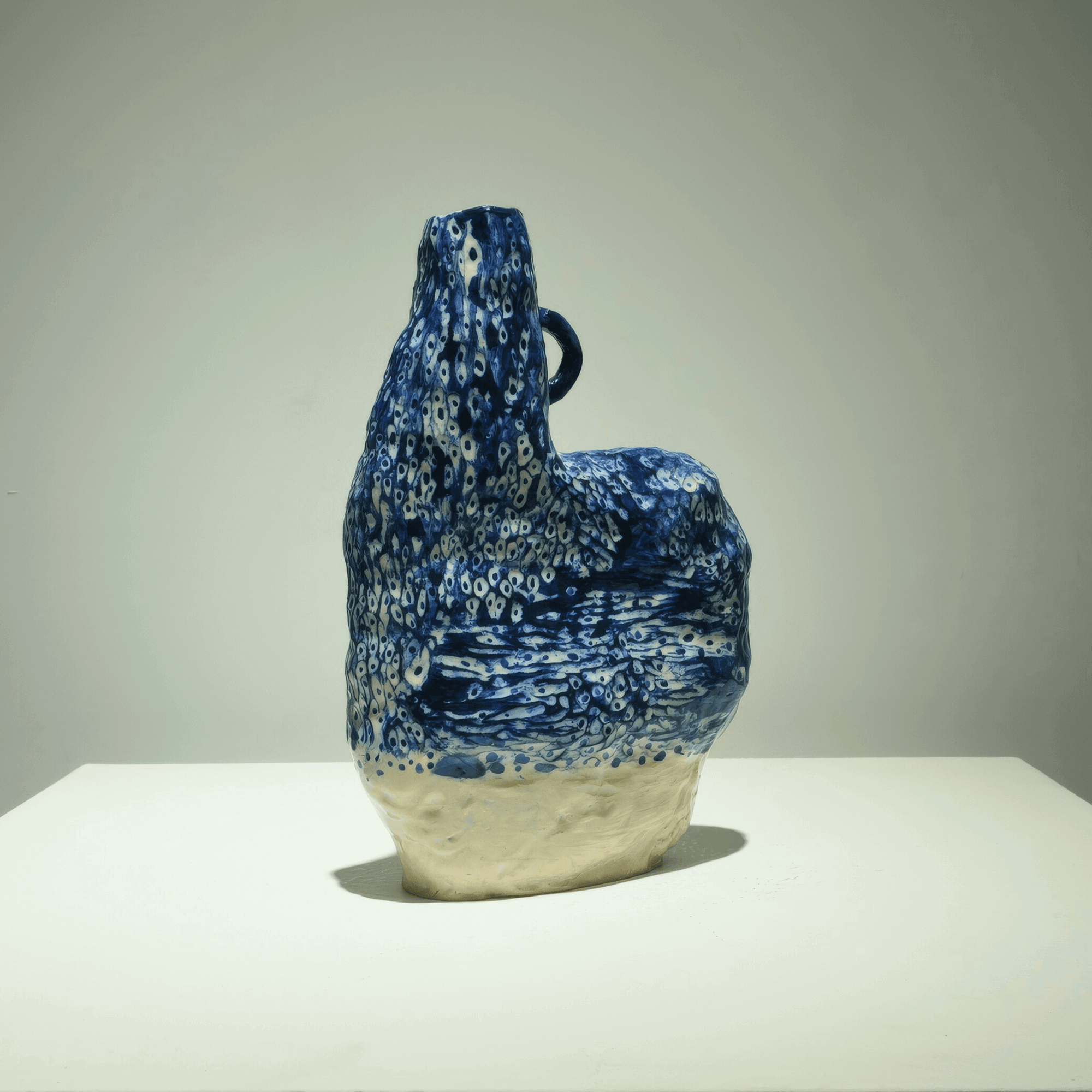 Abstract ceramic art by Supmanee Chaisansuk with cobalt oxide glaze, 20 H x 15 W x 8 cm, minimalist design.