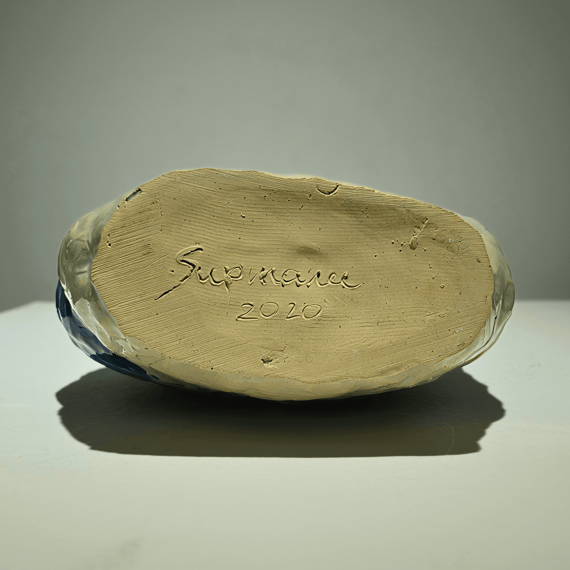 Bottom view of Supmanee Chaisansuk's ceramic art piece showing signature and date 2020.