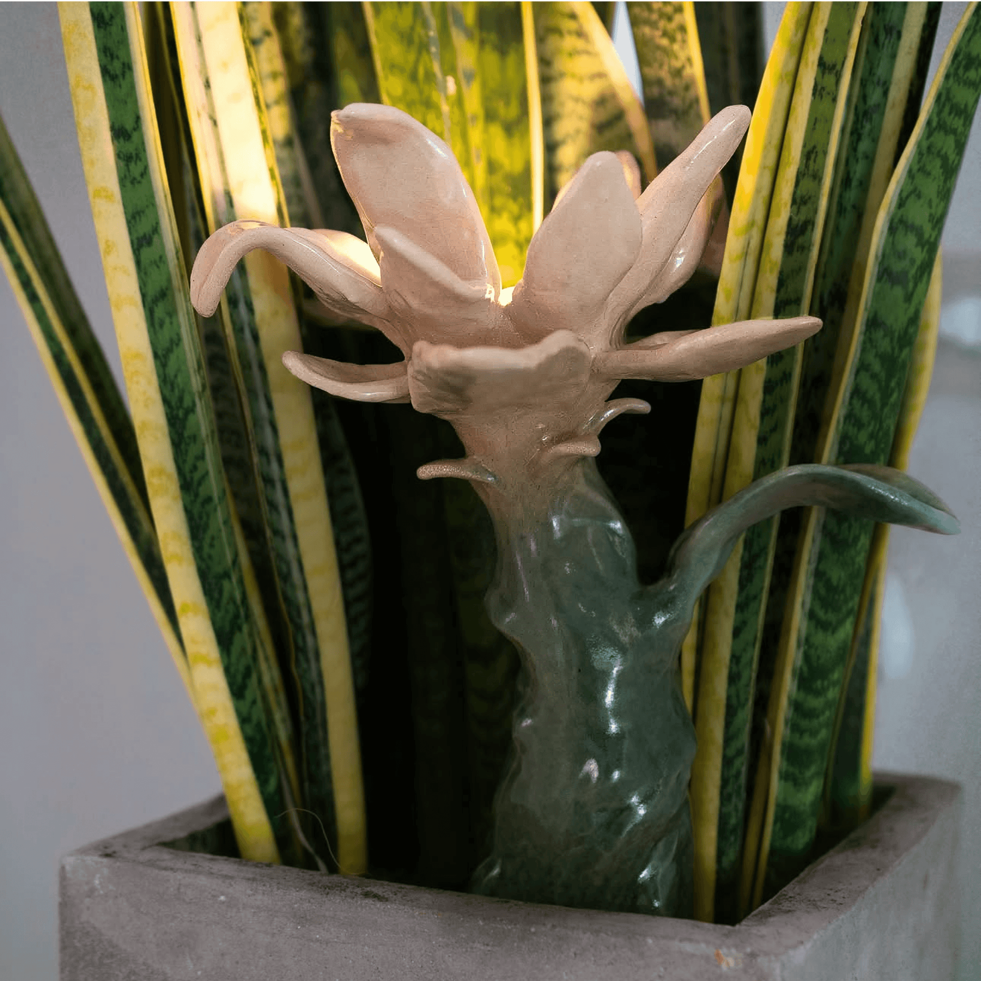Ceramic abstract sculpture by Yasy Bachurina featuring a flower-like form with integrated light, blending art and design.