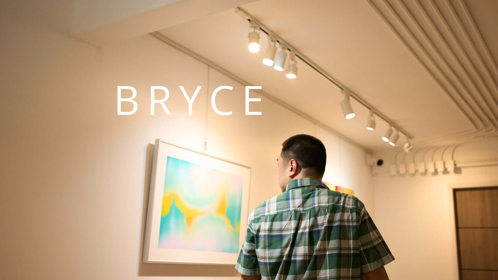 Artist BRYCE viewing art in gallery under bright lights