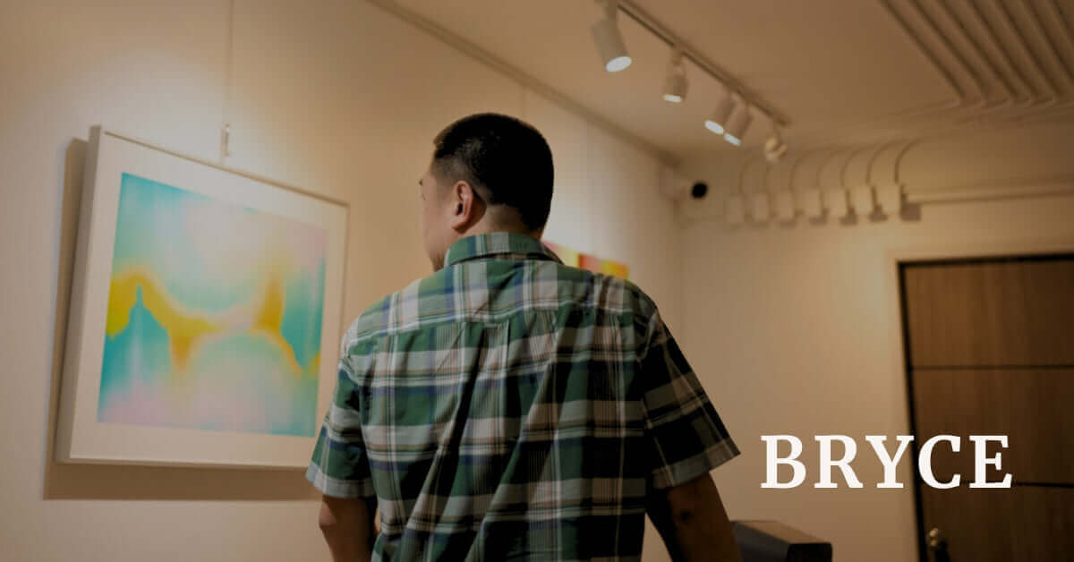 Artist BRYCE admiring his artwork in a gallery, showcasing creativity and artistic vision.