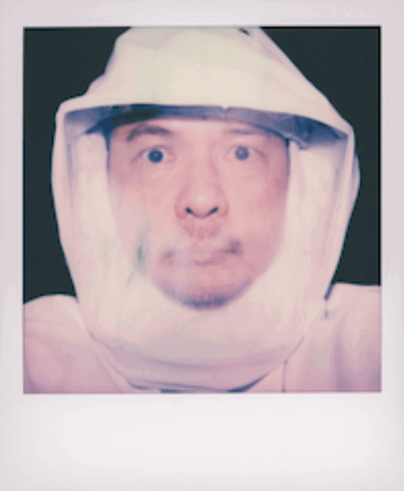 Portrait of BRYCE Watanasoponwong in a white hooded suit.
