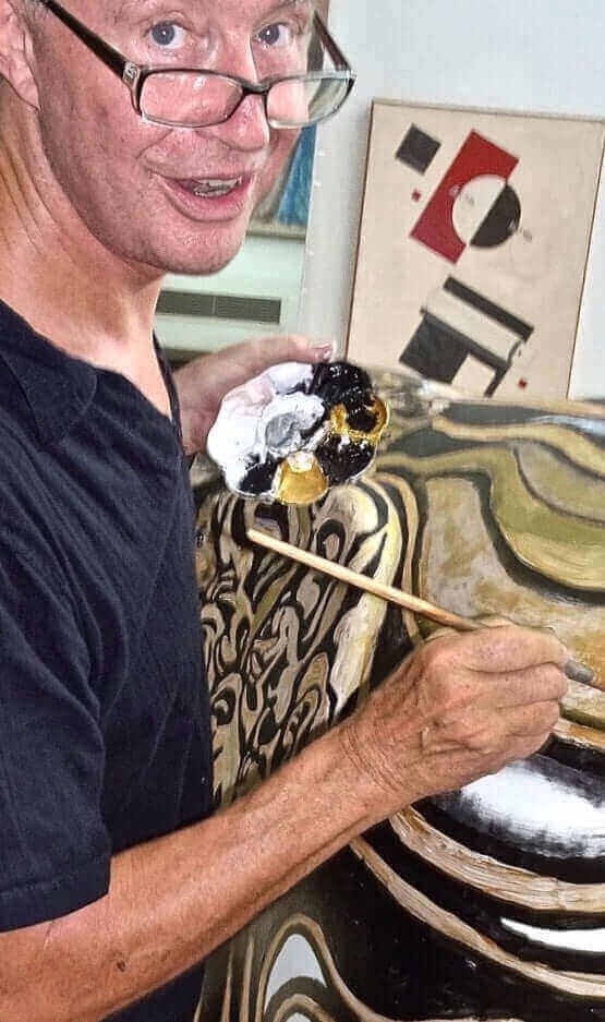 Rudolf Beger painting detailed artwork with a brush.