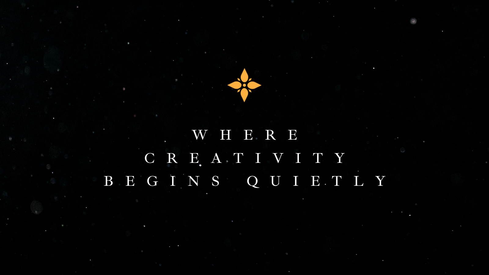 Text graphic reading 'Where Creativity Begins Quietly' on a black background with a gold emblem.