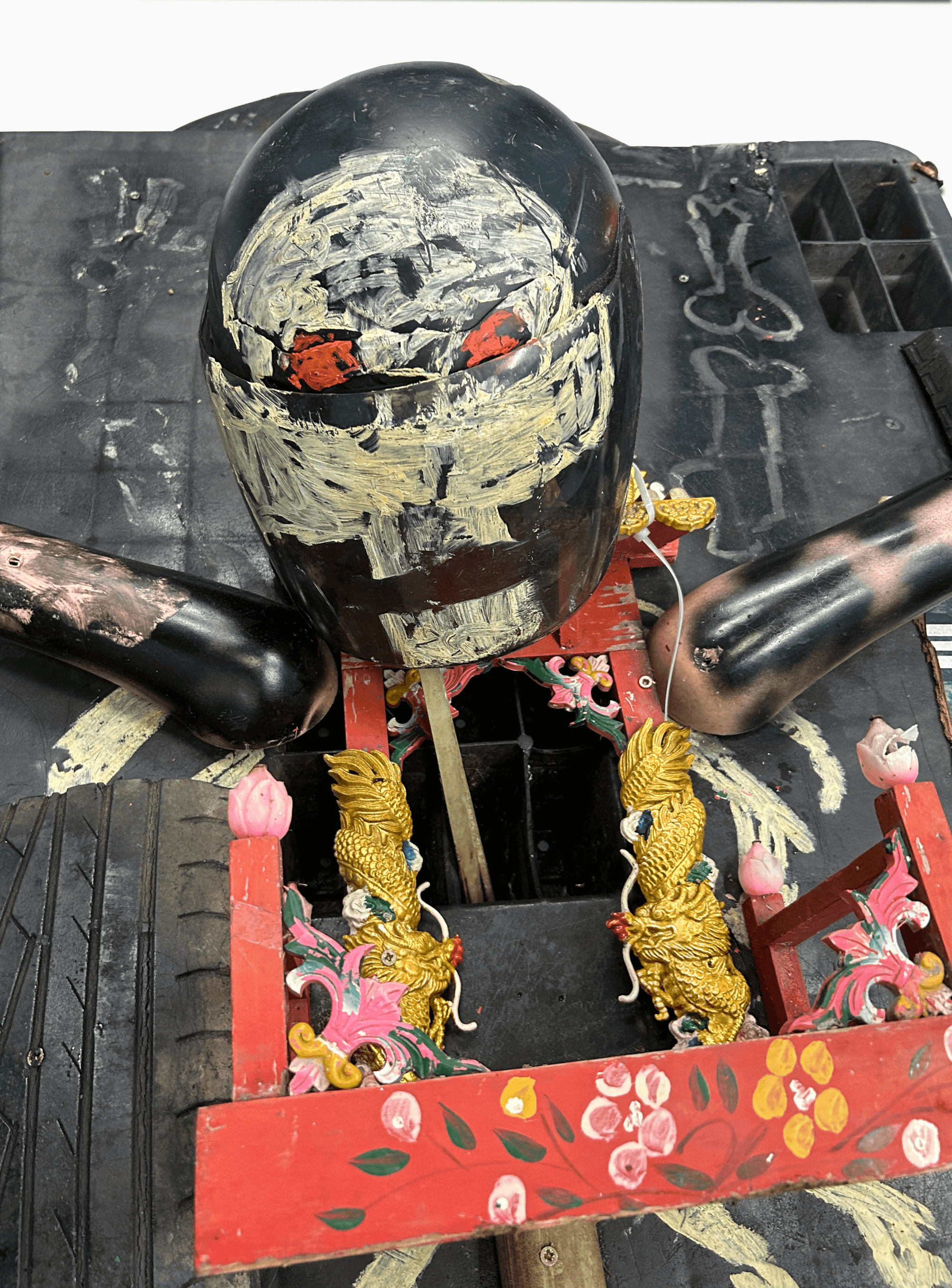 Artistic representation of a traditional puppet with a detailed head and ornate decorations, showcasing intricate craftsmanship.