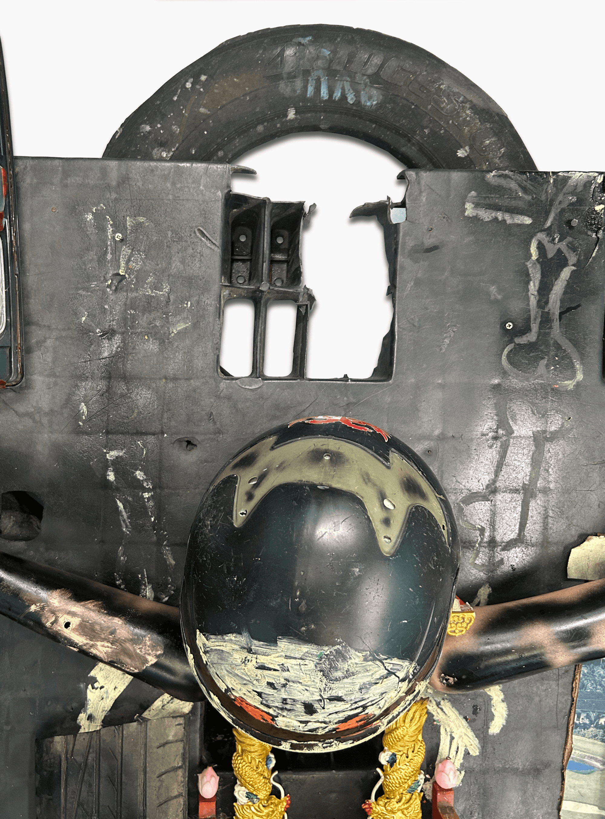 Close-up view of a unique helmet mounted on a textured black surface, featuring various details and textures.