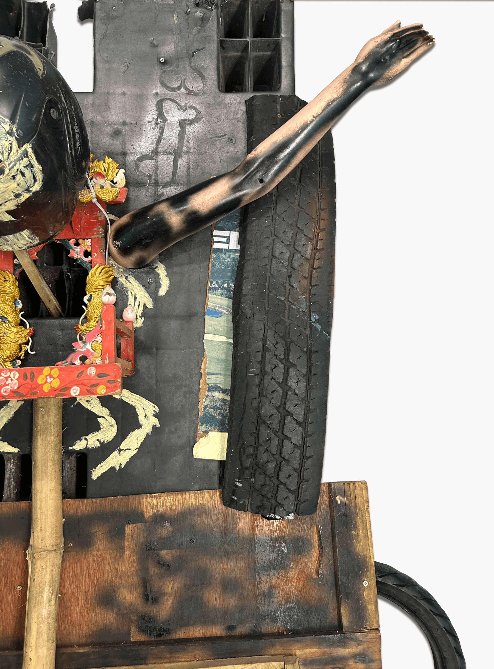 Artwork featuring a unique assemblage of a tire, an arm, and decorative elements, showcasing contemporary art creativity.