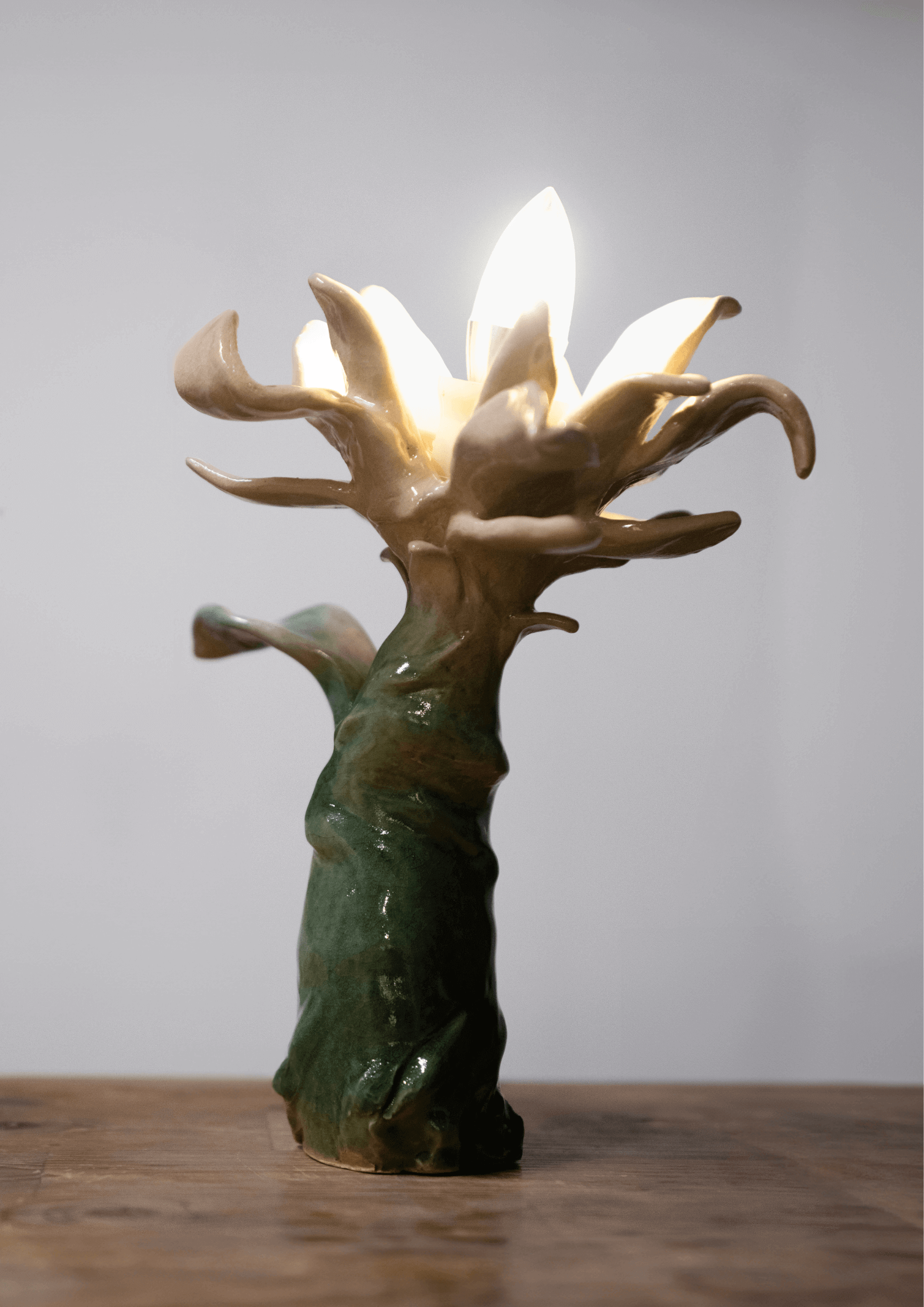 Ceramic sculpture by Yasy Bachurina, resembling a flower with a light bulb, in abstract surrealism style, 2024.