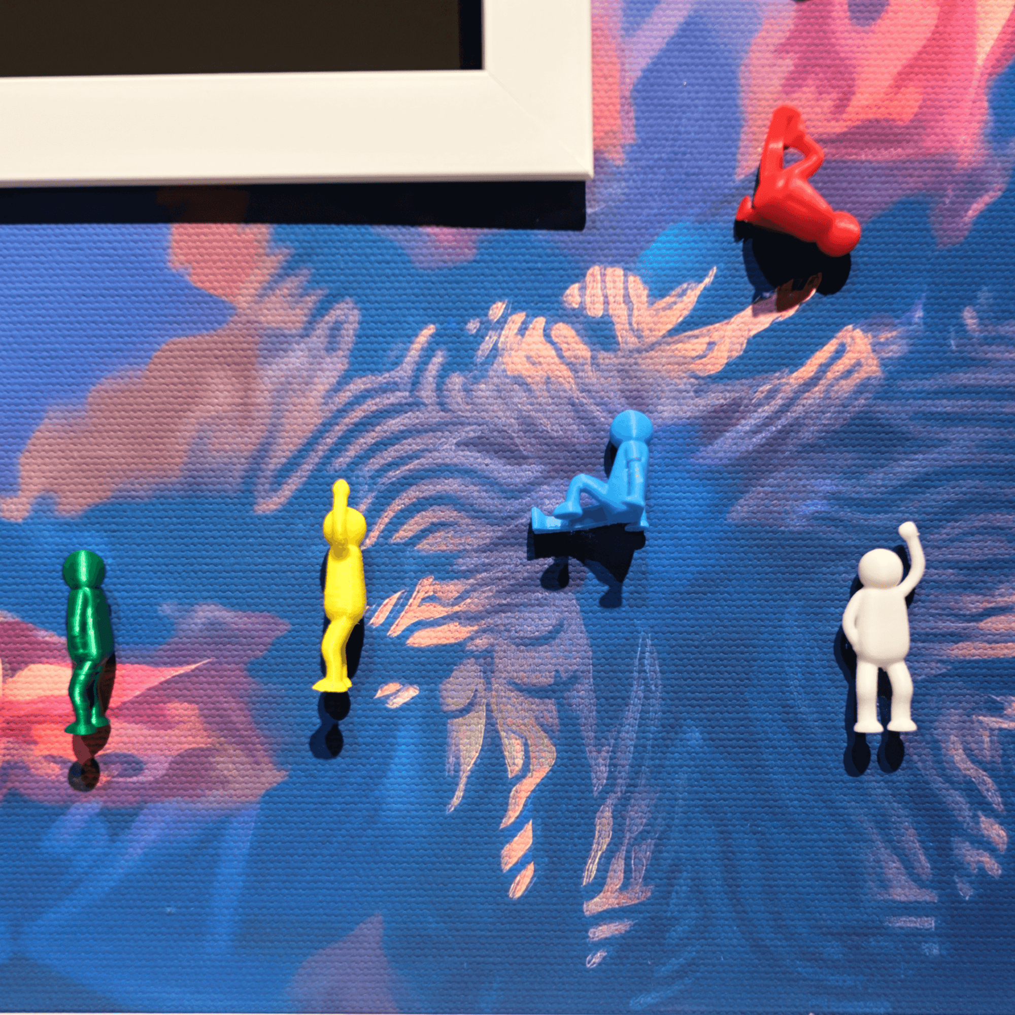 Colorful plastic figures in various poses on a vibrant, abstract background.