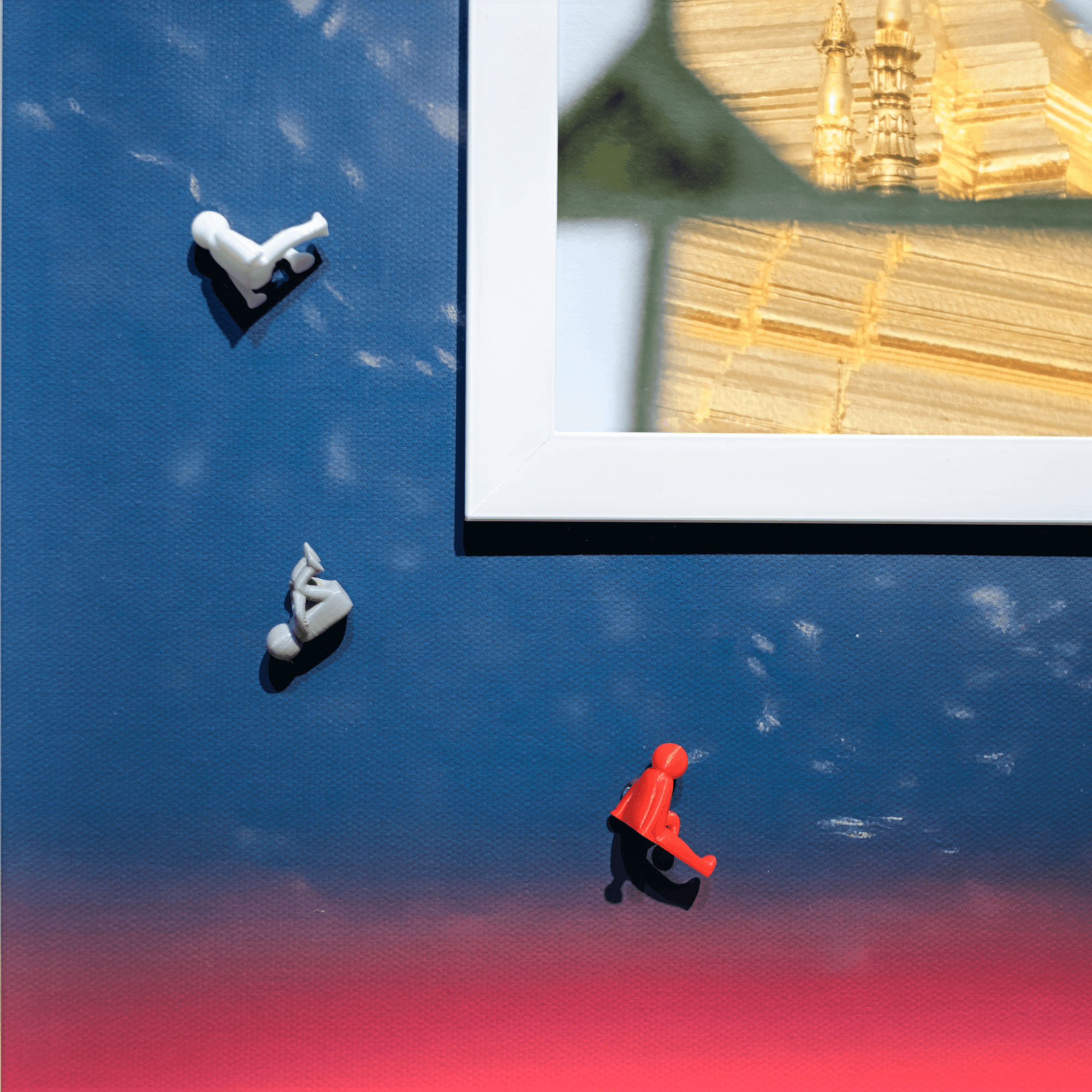 Art installation featuring figurines against a colorful backdrop, showcasing creativity and design elements.