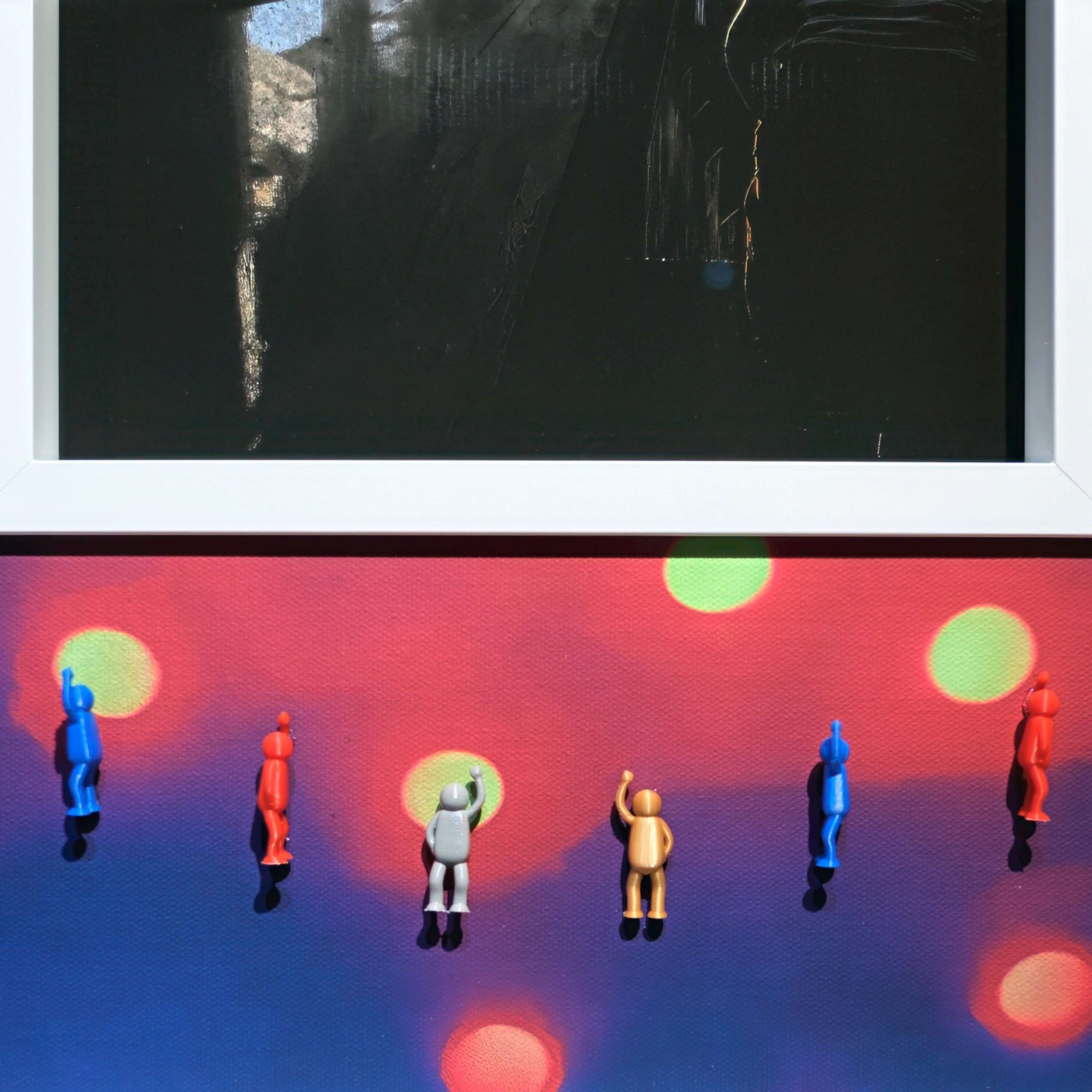 Colorful figurines against a vibrant bokeh background in the artwork titled Flash of Light, 2025.