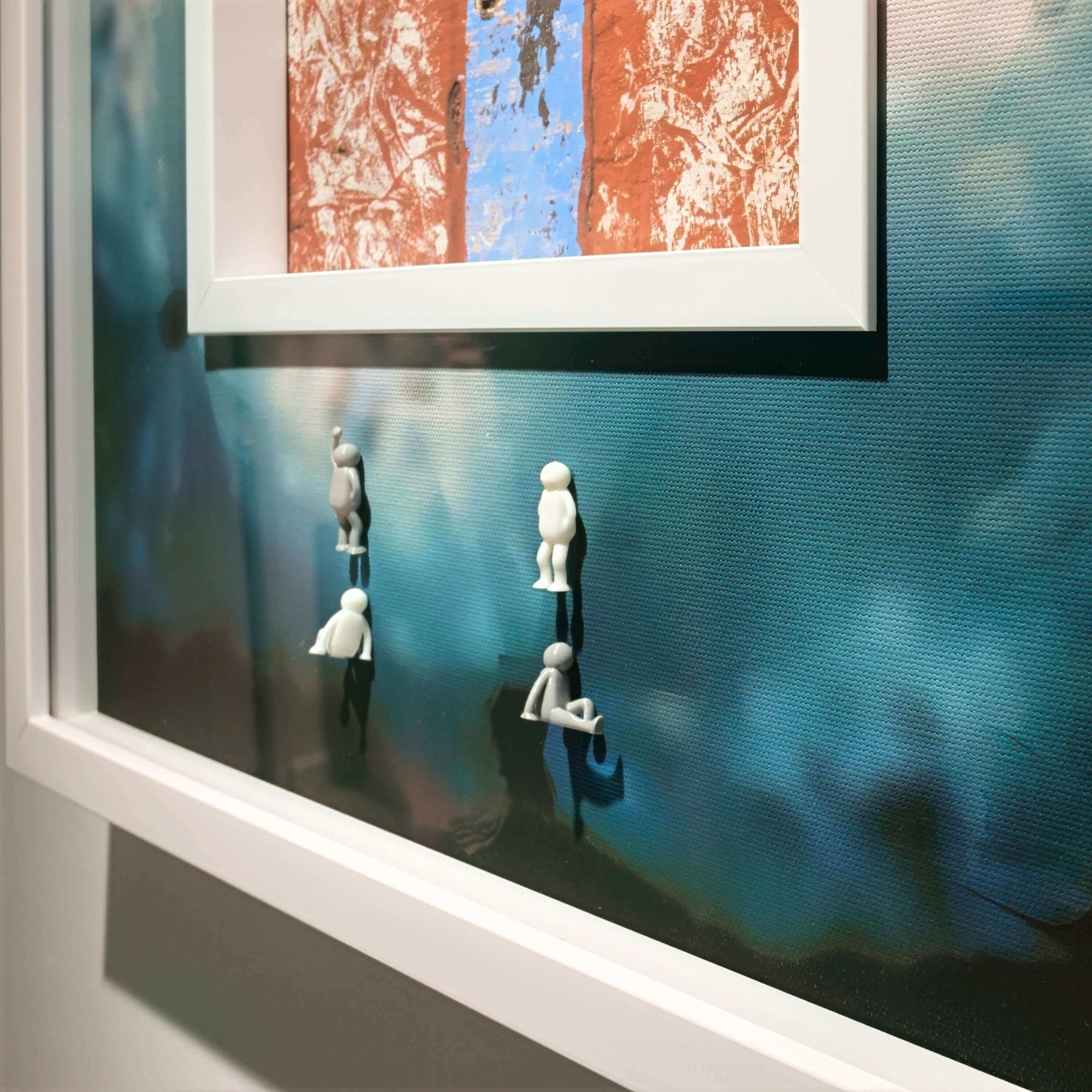 Artwork featuring three miniature figures interacting with a cracked surface backdrop, enhancing the visual narrative of Cracked Surface, 2025.