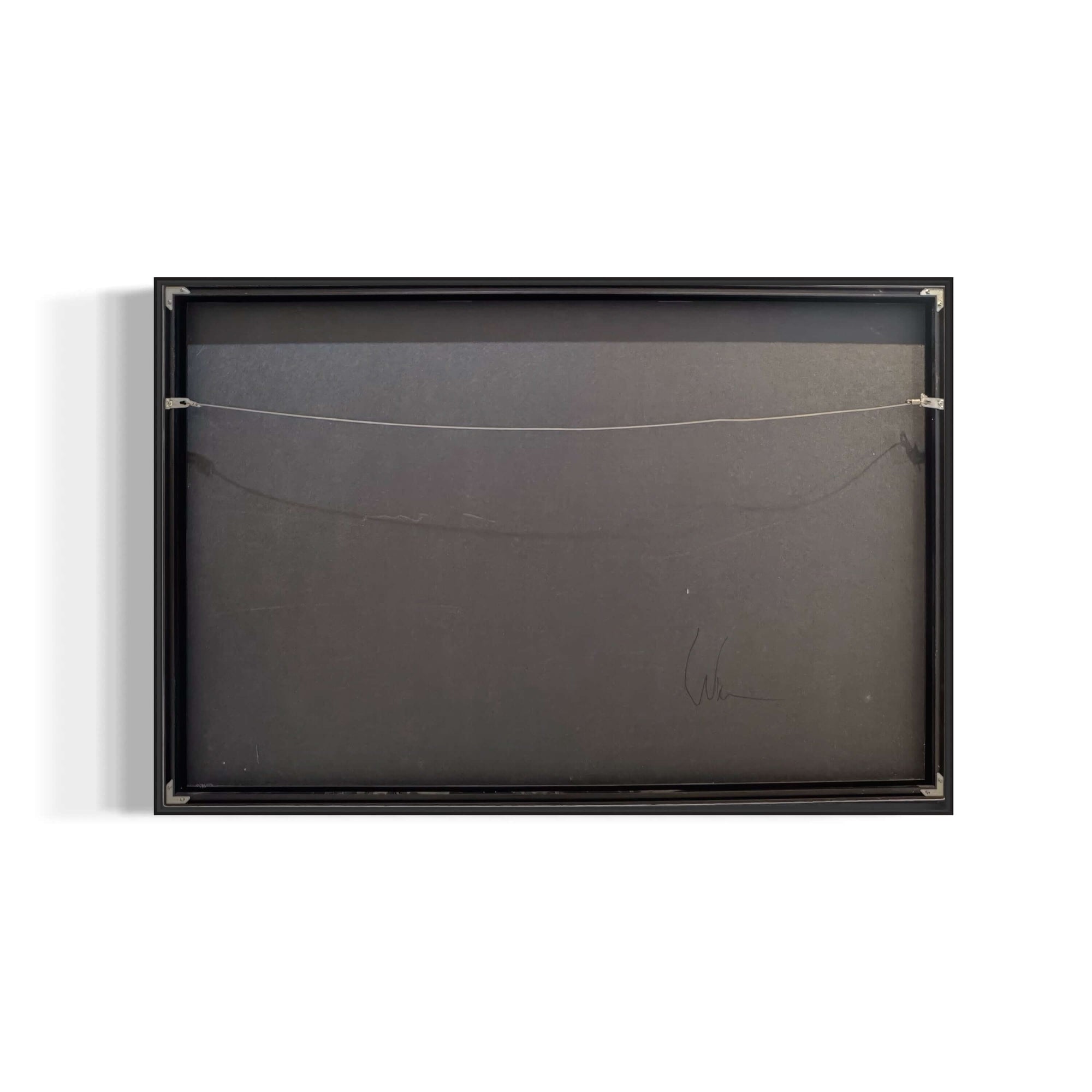 Back view of framed artwork with signature, showcasing hanging wire and black backing.