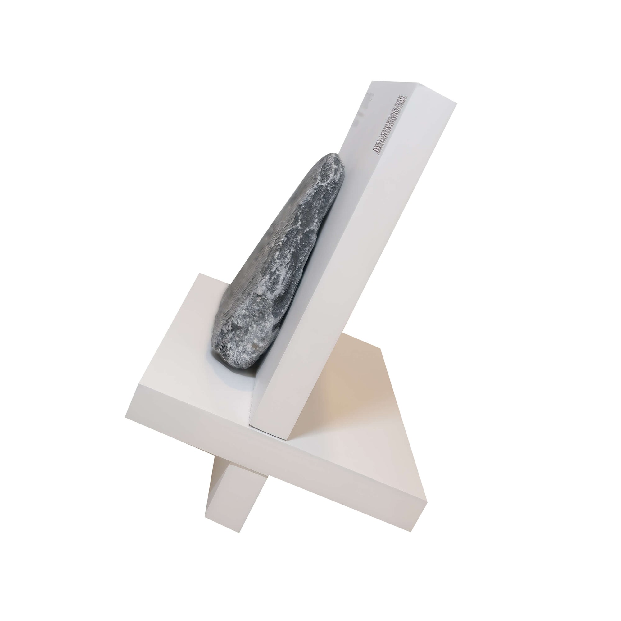 Modern sculpture featuring a stone positioned on a minimalist white support, showcasing balance and design.
