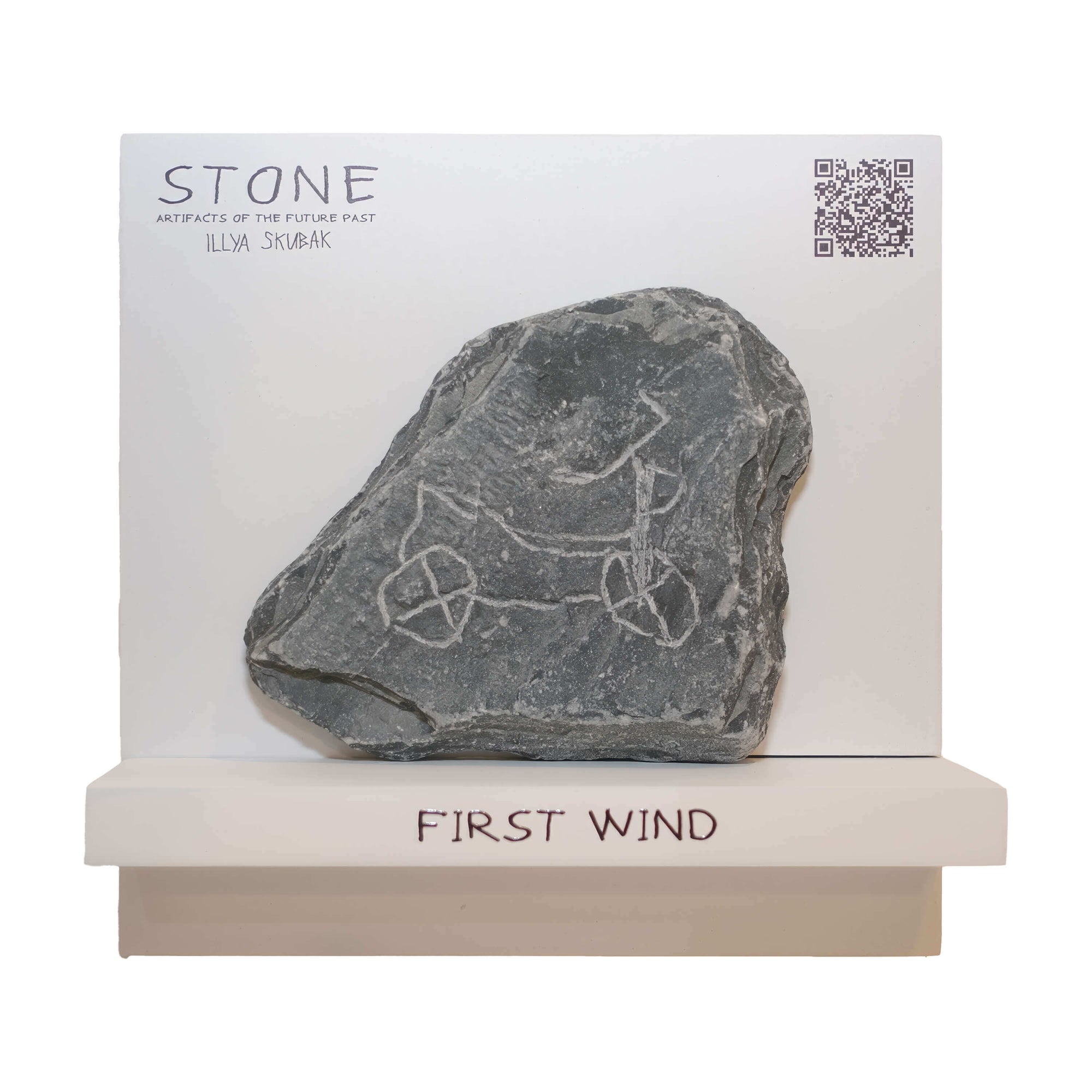 Stone artifact titled 'FIRST WIND' featuring a wheeled drawing on a gray rock by artist Illya Silvka.