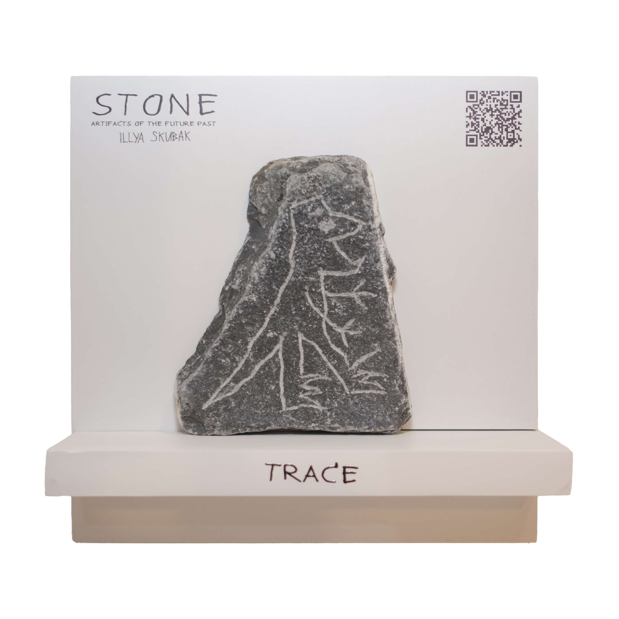 Decorative stone artifact labeled 'TRACE', showcasing intricate markings and displayed on a white background.