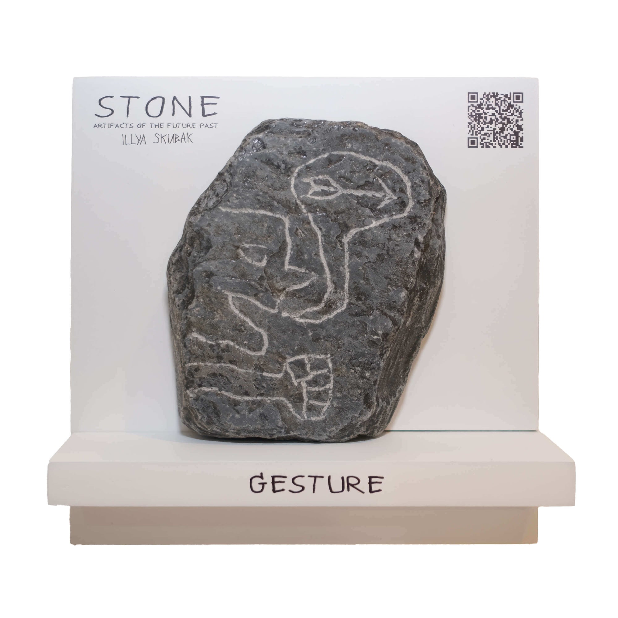 Artifact titled 'Gesture' featuring a carved stone with etched human figures on a display stand.