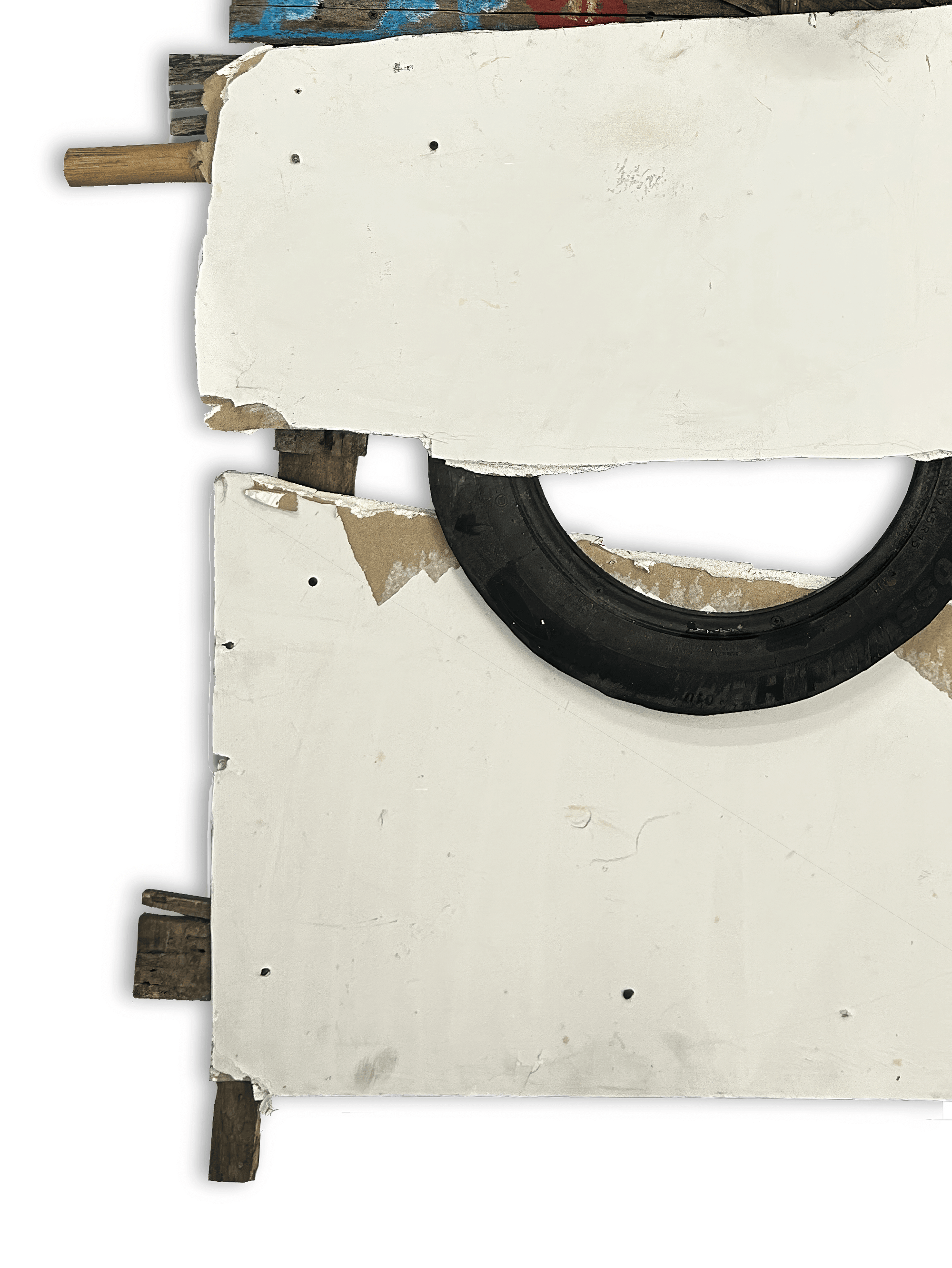 A creative composition featuring a circular black tire mounted on a white surface with wooden supports and colorful paint accents.