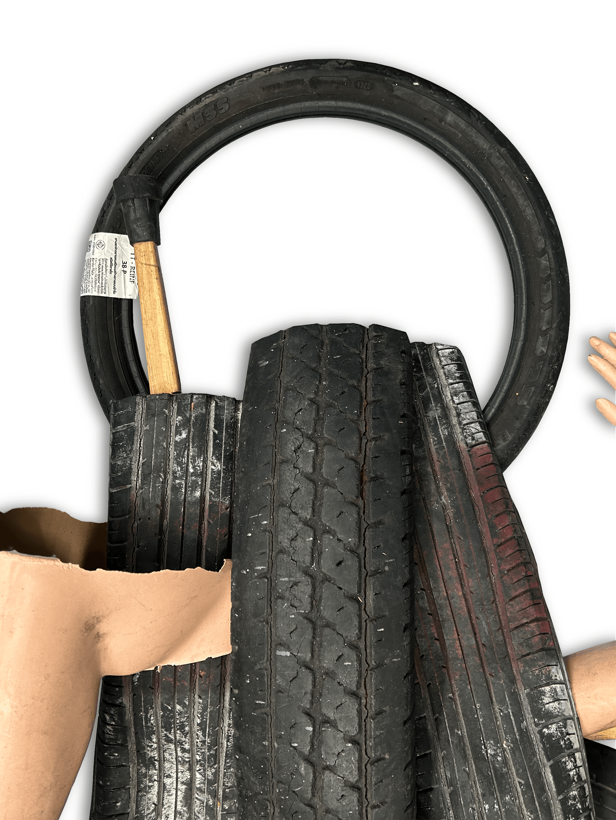 A collection of worn tires and a wooden tool, layered over a background, showcasing various textures and materials.