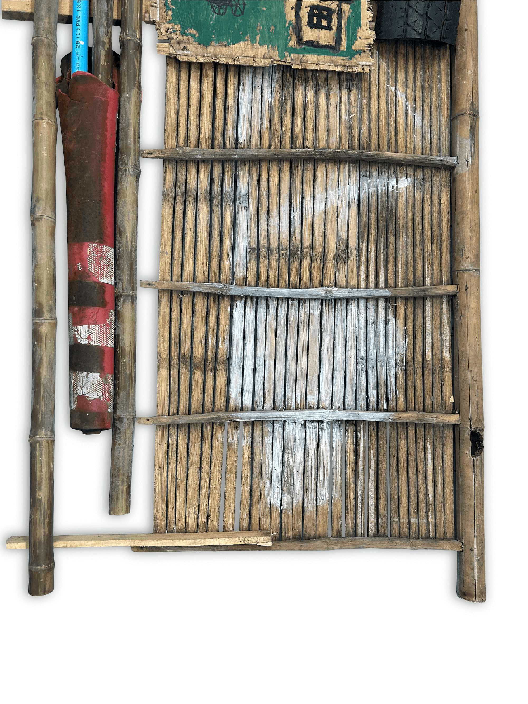 Top view of a wooden structure with bamboo slats and various tools placed on it, highlighting a rustic and handcrafted design.
