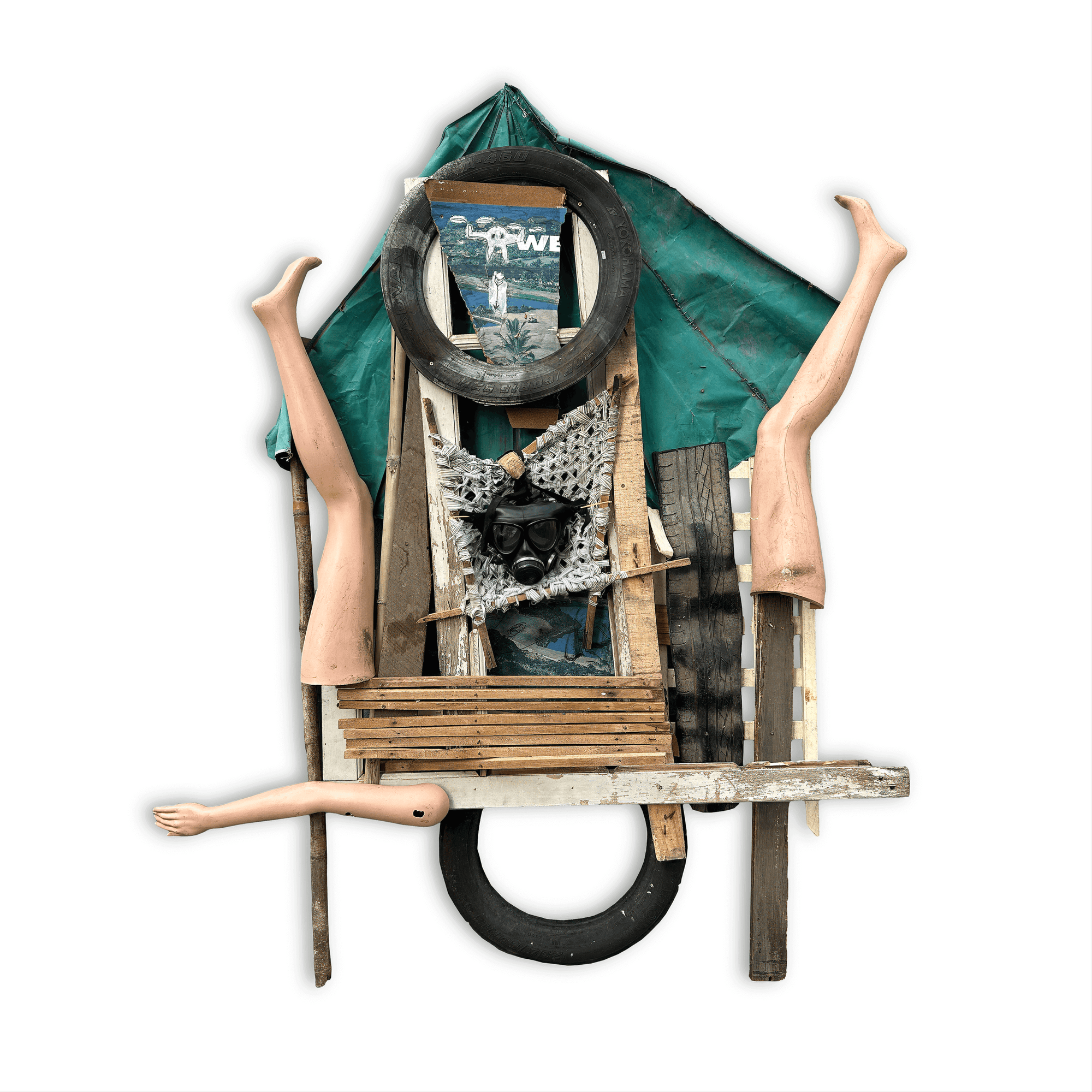 Abstract art piece featuring mixed media, including mannequin legs, tires, wood, and a green tarp.
