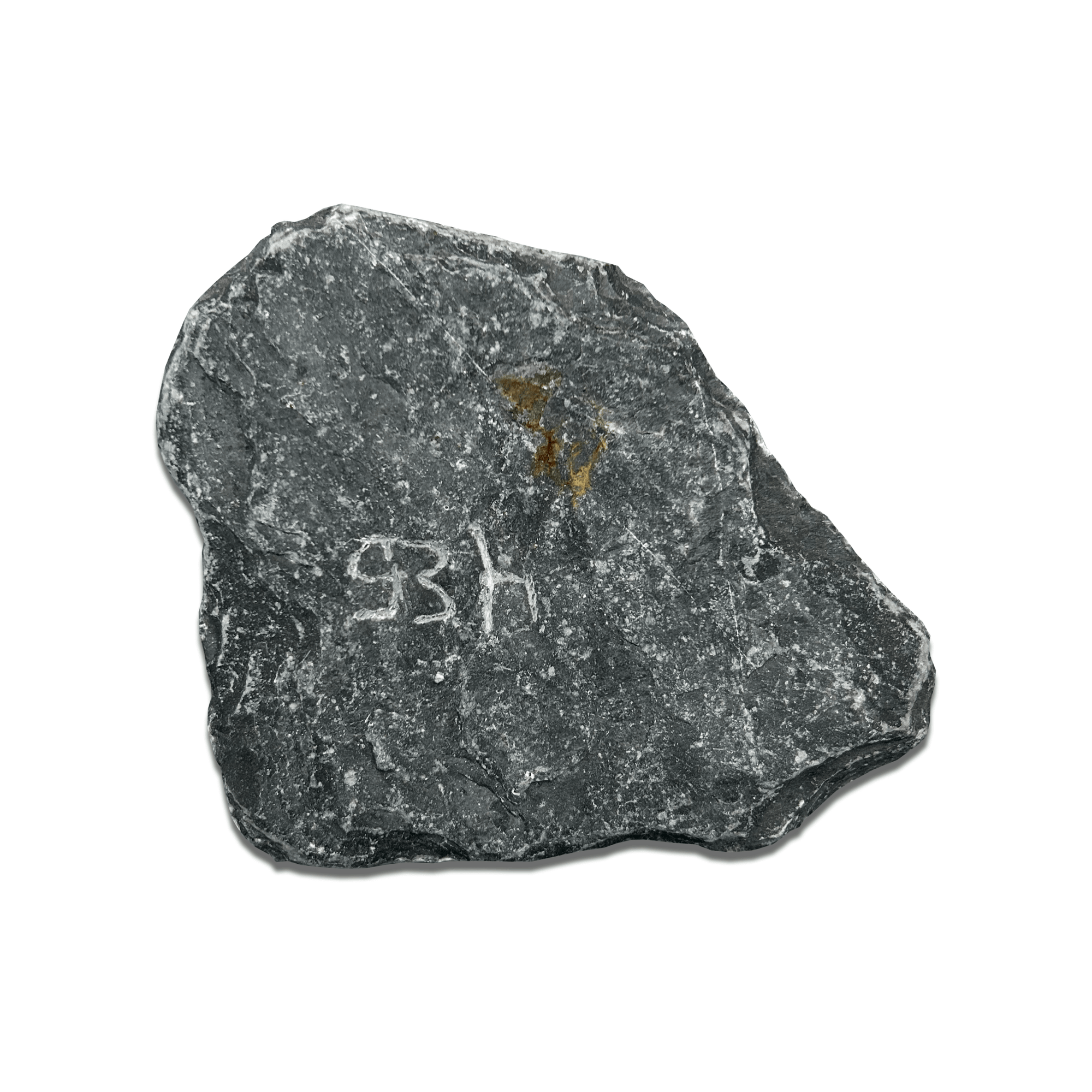 Close-up of a textured black rock with a yellowish mark and white inscription '93h'