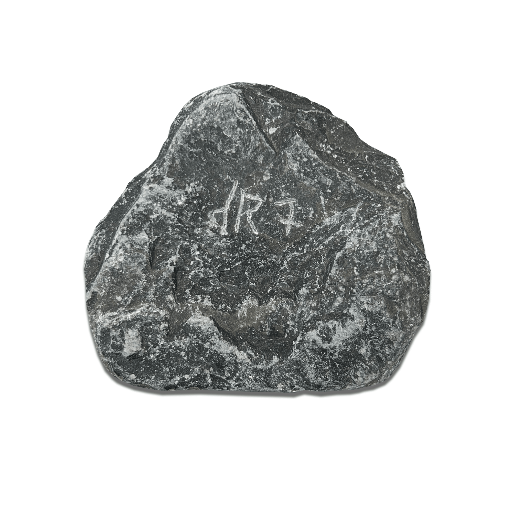 Dark stone with ancient carvings, showcasing historical markings and textures on the surface.