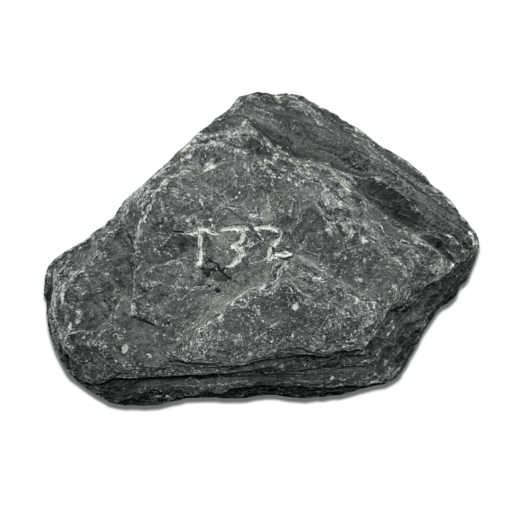 Textured dark stone with engraved number 132, showcasing natural rock formations.