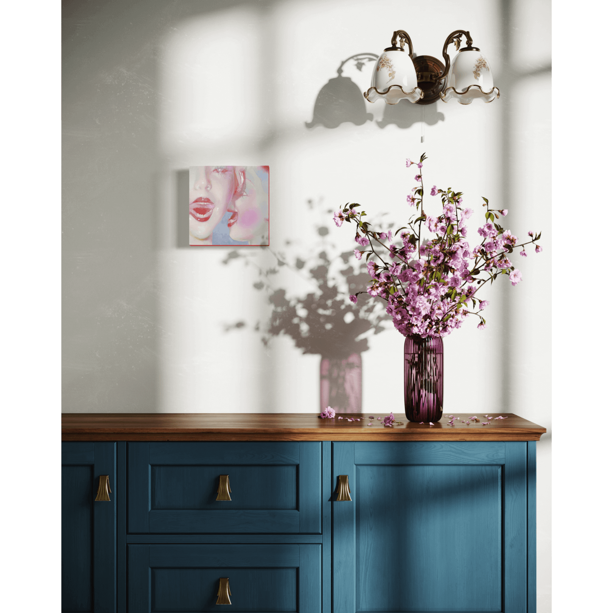 Blue dresser with pink flowers in a vase, abstract painting on the wall, under a vintage wall lamp.