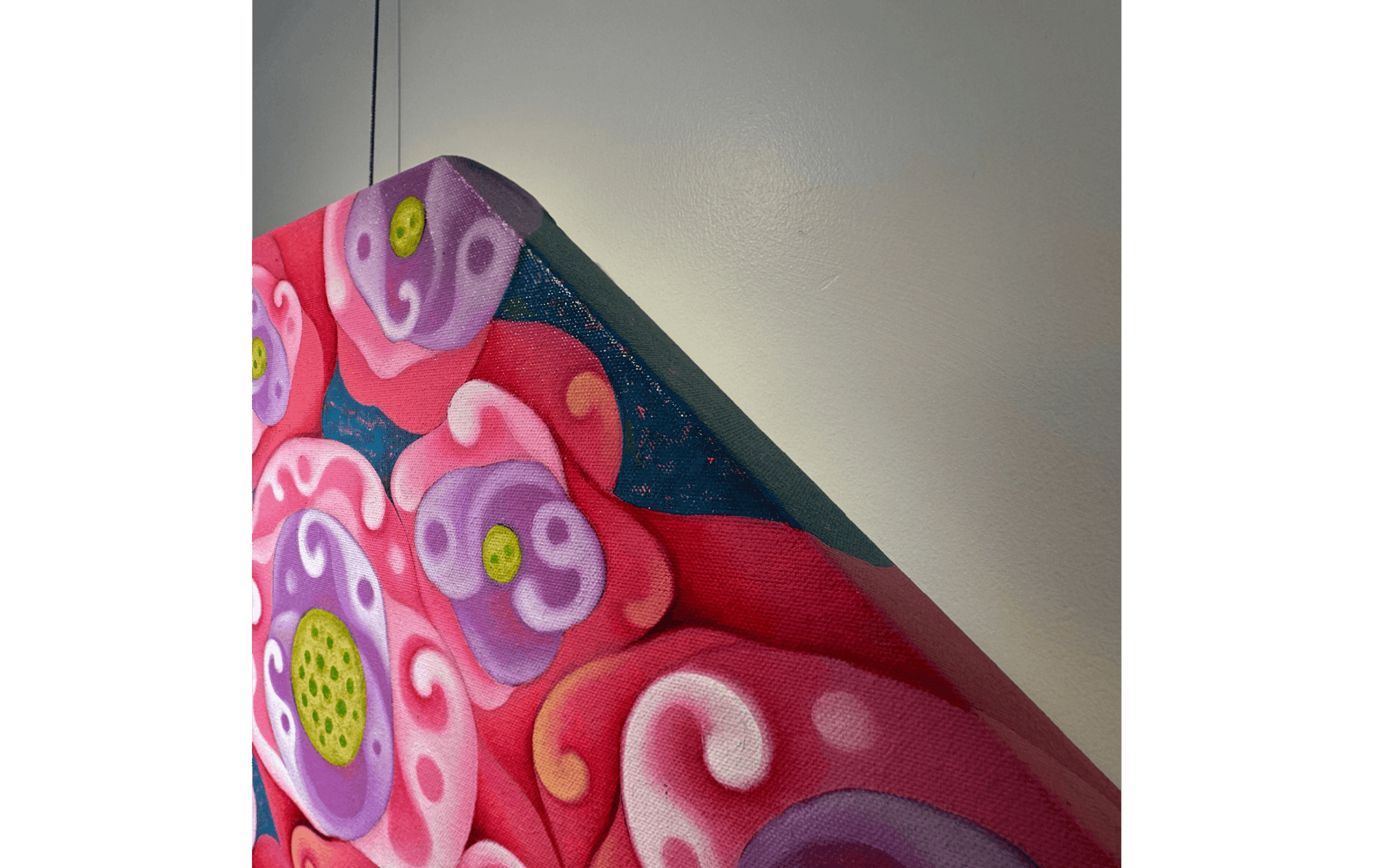 Detail view of the octagonal canvas of Pink Lotus (2022) by Chalah Chaveesuk with floral artwork.